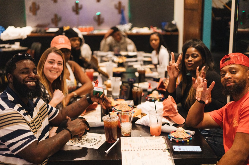 Friends celebrating around a table at Nacho Padres
